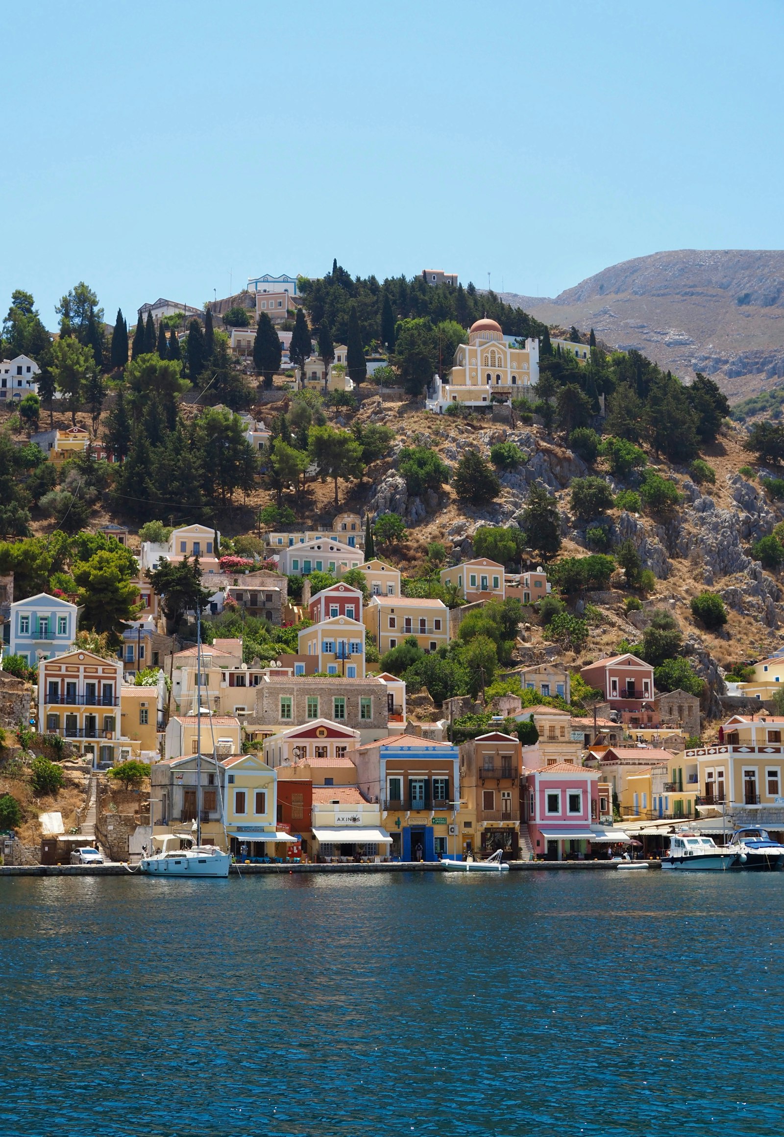 Colourful houses above the harbour of Symi